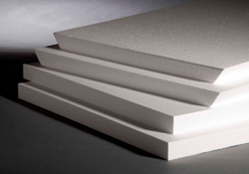 Stack of four white EPS rigid insulation boards. The top two are tapered. The bottom two are not.
